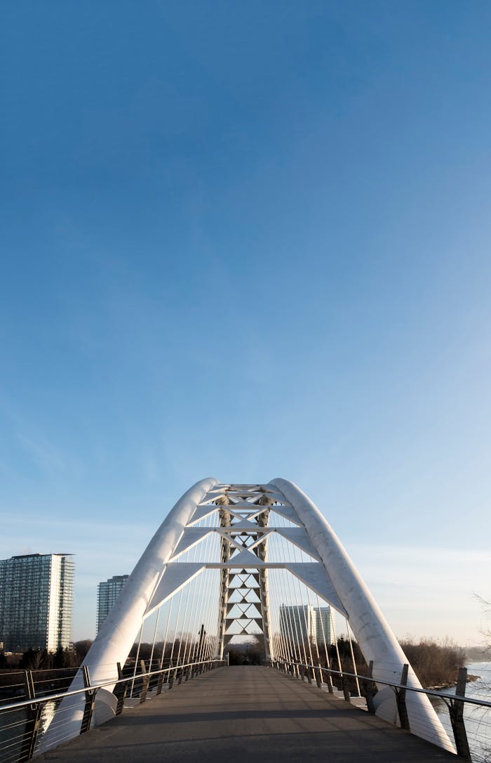 View of the Humber Bay Arch Bridge with clear blue skies in Toronto.